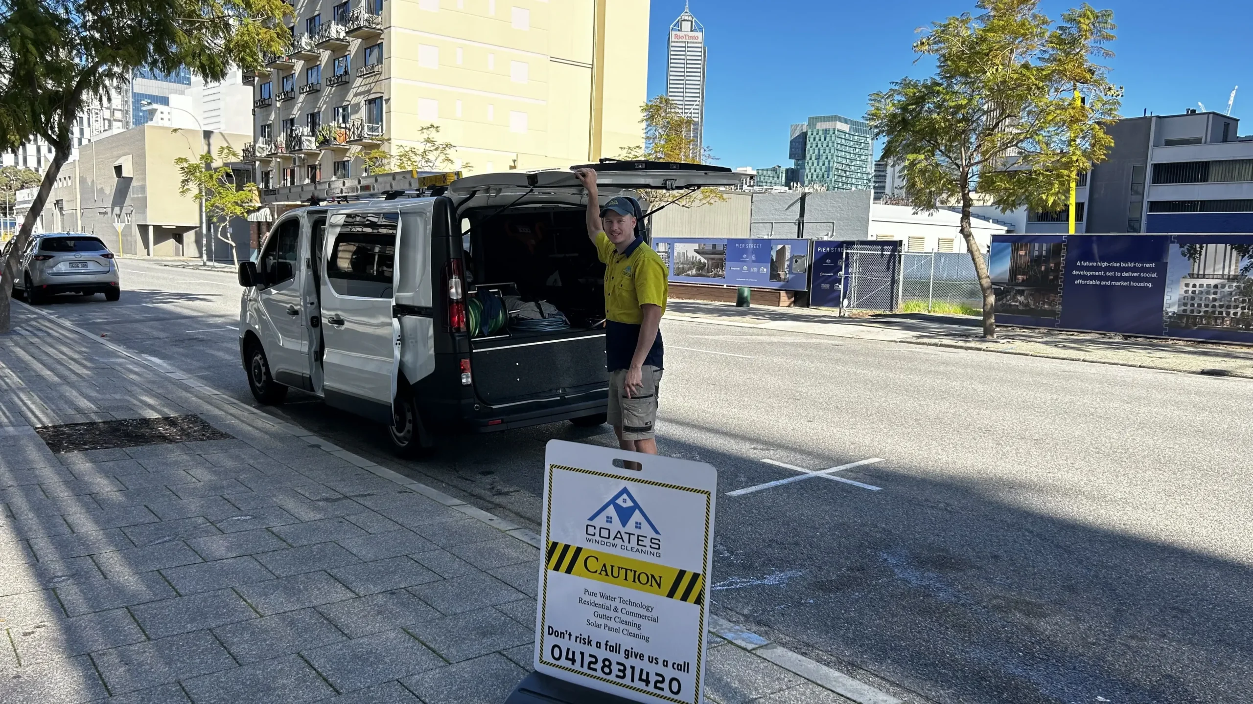 Coates Window Cleaning van and technician set up for a commercial job on a Perth street