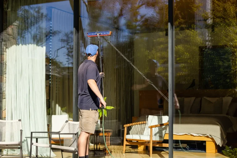 Squeegee-finished glass reflecting outdoor seating at a Perth home