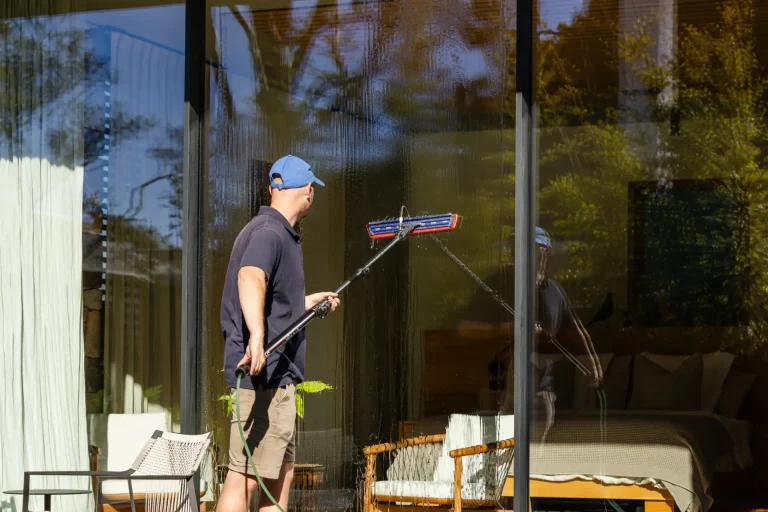 Long-handled squeegee window clean outside a modern Perth residence