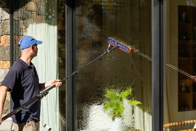 Telescopic pole cleaning a large wet window pane in Perth