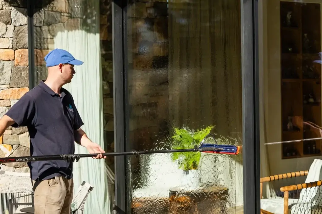Brush-head pole cleaning an exterior window of a Perth building