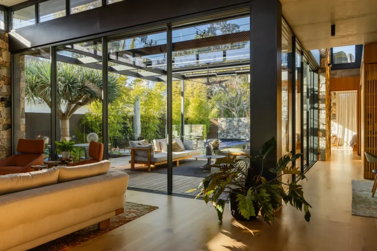 Streak-free glass walls opening a Perth living room to its patio