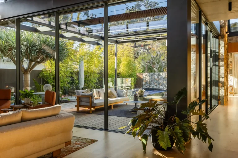 Clean floor-to-ceiling glass connecting living room and landscaped backyard in Perth