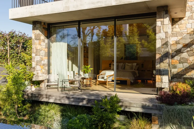 Stone home in Nedlands, Perth, with spotless glass doors opening onto the deck