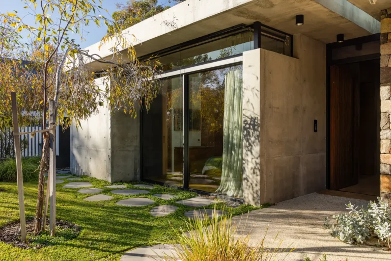 Concrete home with gleaming glass sliding door and landscaped garden in Perth