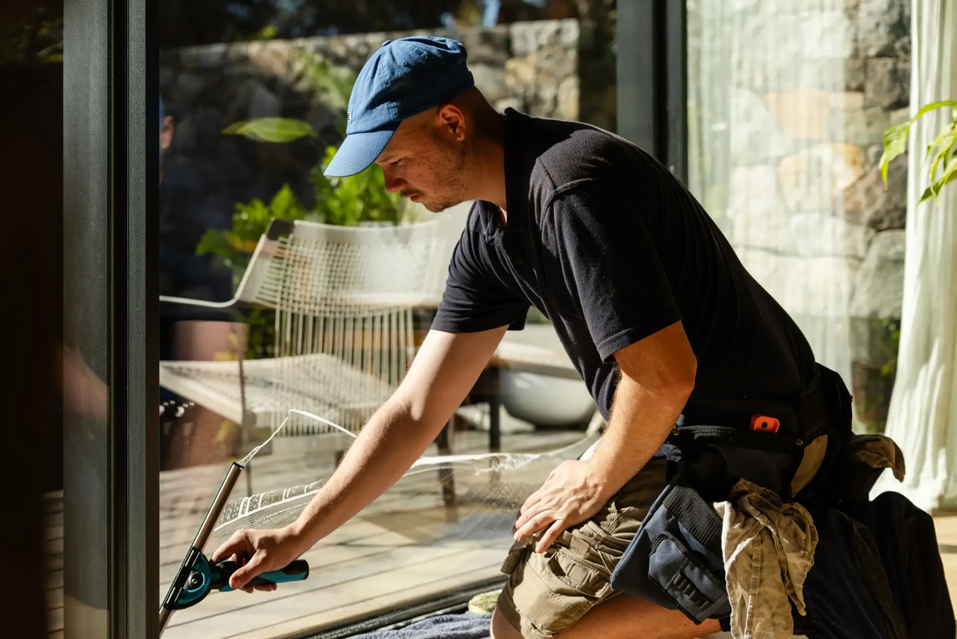 Indoor glass door cleaning with a squeegee at a Perth residence