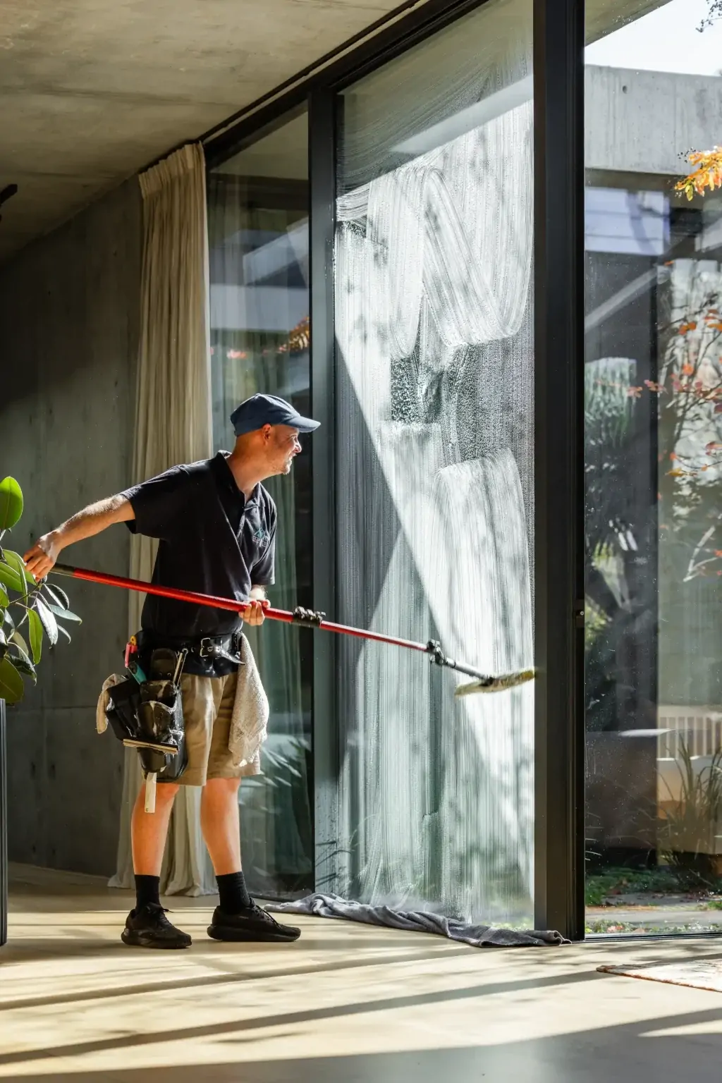 Interior window cleaning with sunlight streaming through at a Perth home