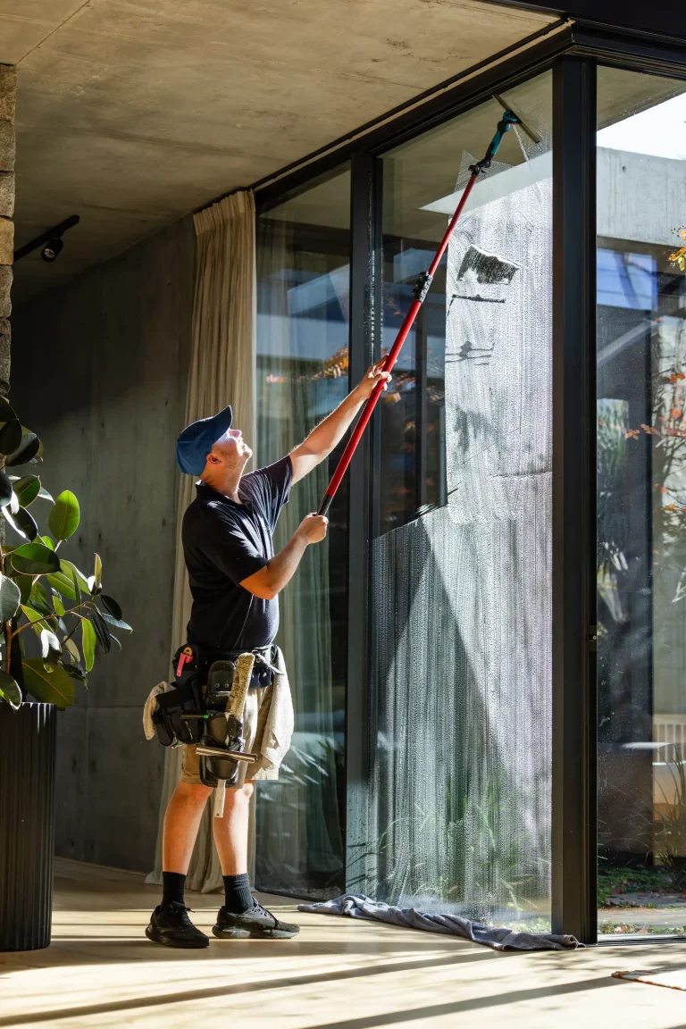 Floor-to-ceiling window cleaning inside a modern Perth property