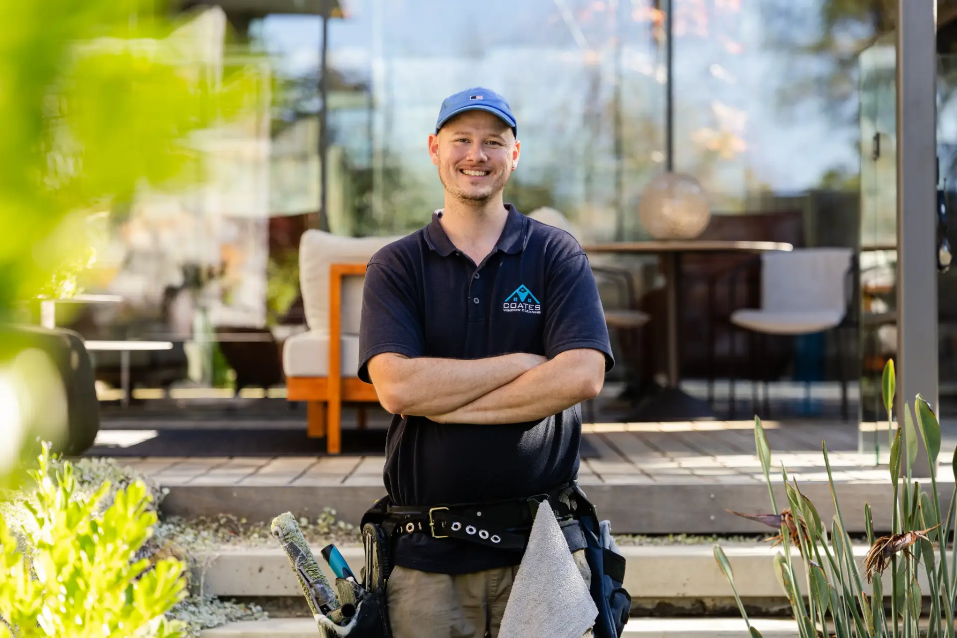 Coates Window Cleaning technician with arms crossed outside a Perth building