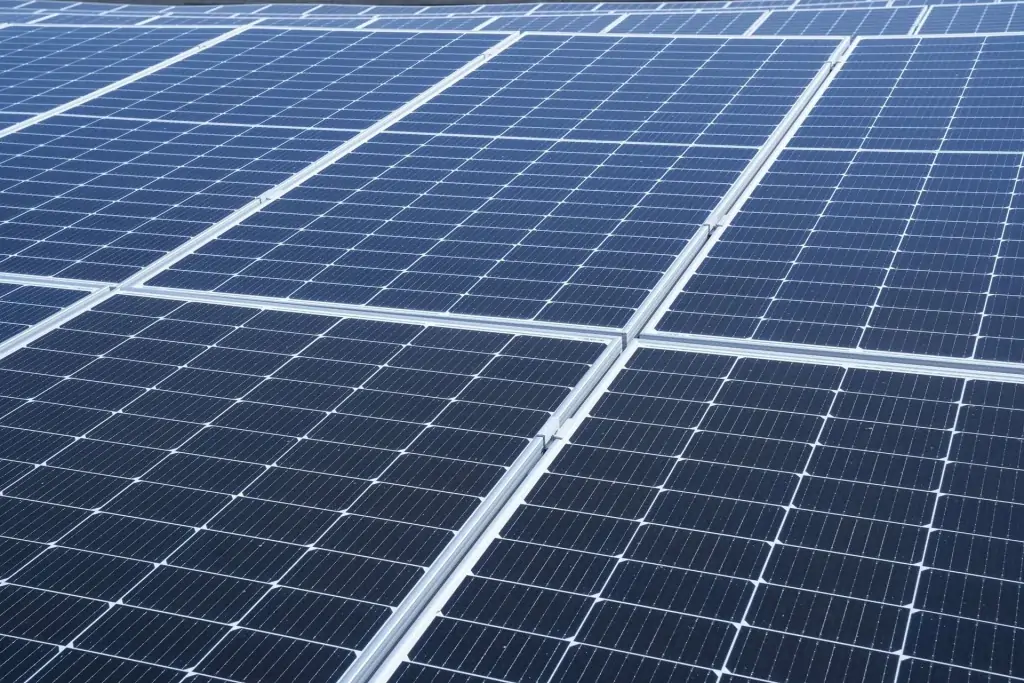 Close-up view of multiple rows of blue solar panels installed outdoors, showing the grid pattern and reflective surfaces—an ideal example of installations that benefit from regular Commercial Solar Panel Cleaning in Perth.