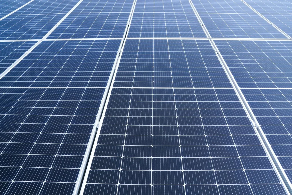 Rows of blue commercial solar panels awaiting cleaning in Perth